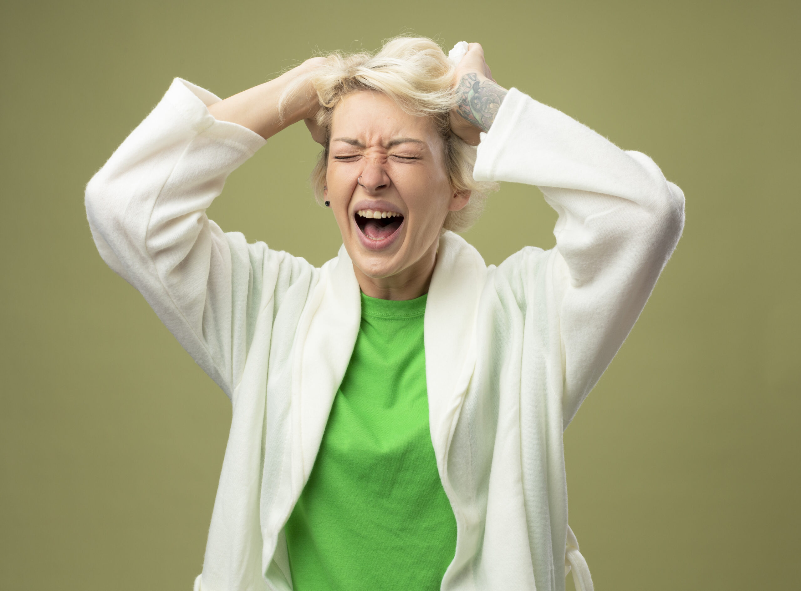 sick-unhealthy-woman-with-short-hair-feeling-unwell-being-frustrated-pulling-her-hair-standing-light-wall